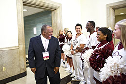 Photo of a man with students. 